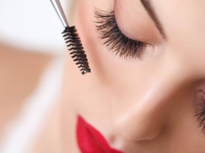 a woman doing her lashes