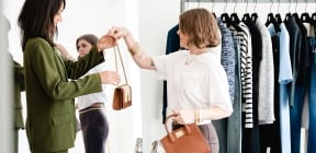 a woman trying out handbags