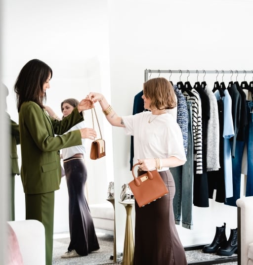 a woman trying out handbags