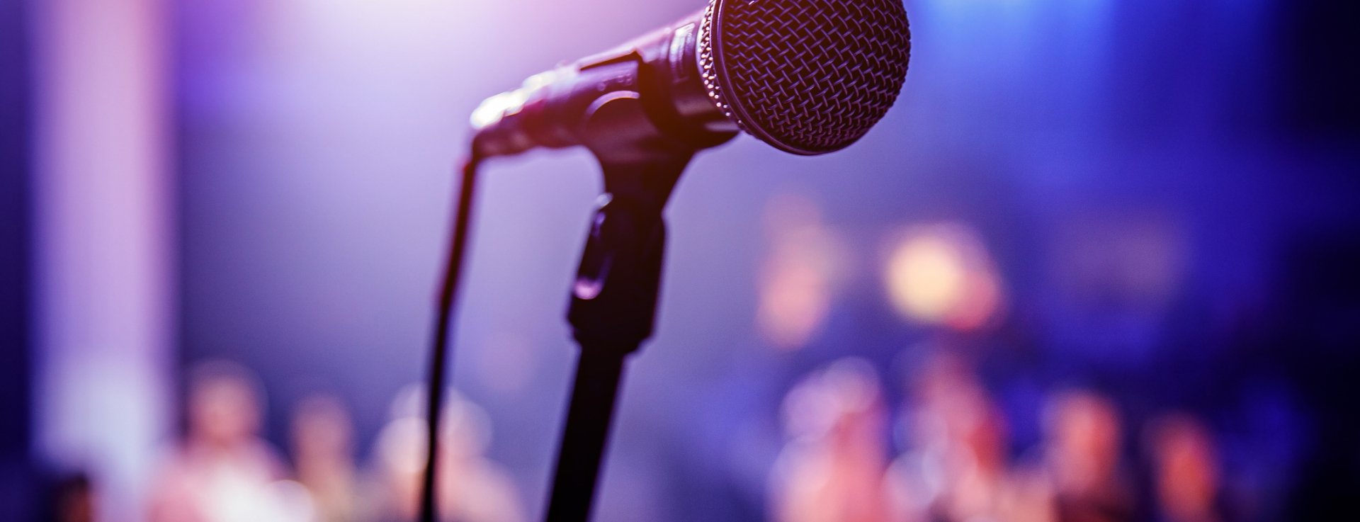 close up of a microphone with people in the background