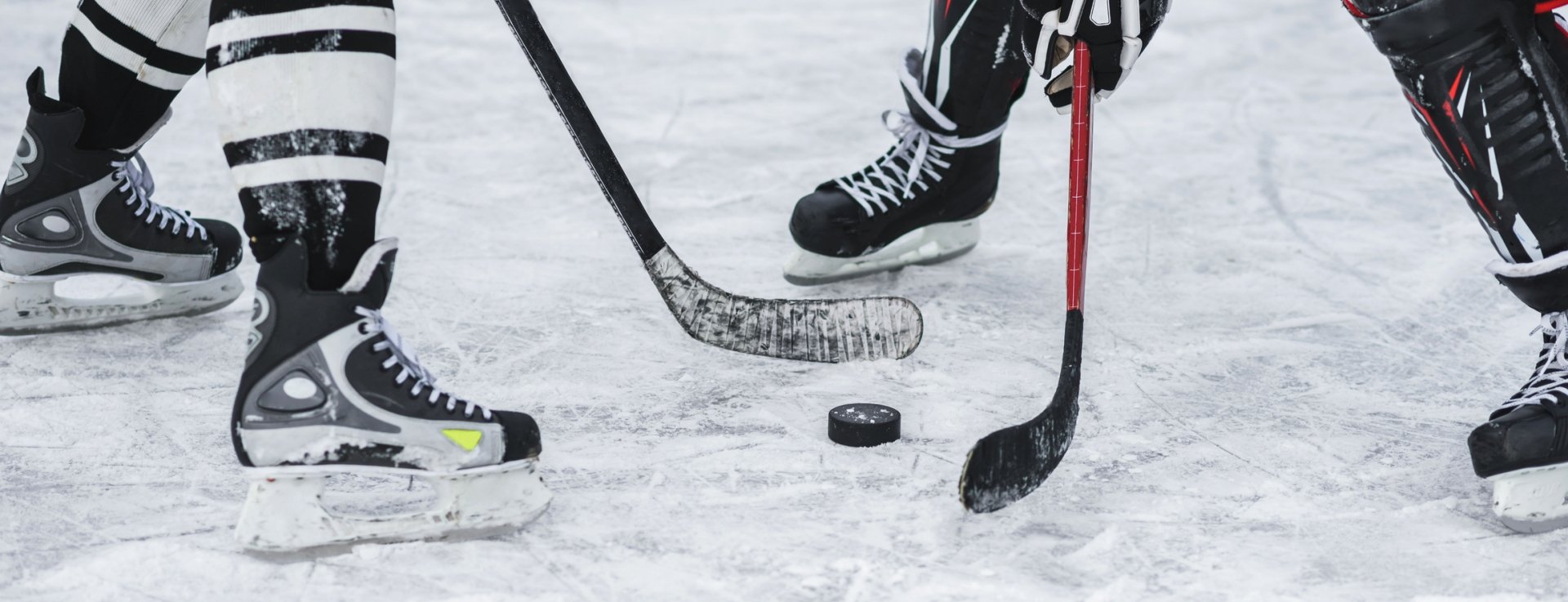 two people playing hockey on the ice