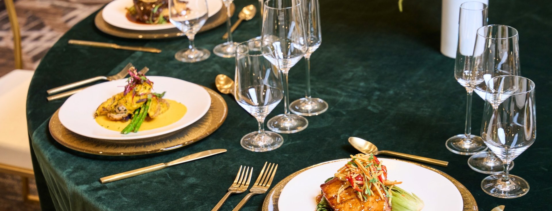 Plates of food on a large round table set up for dinner service at Hotel Clio