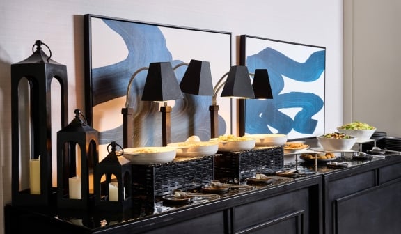 Lots of food on a large table buffet style for guests to eat at Hotel Clio