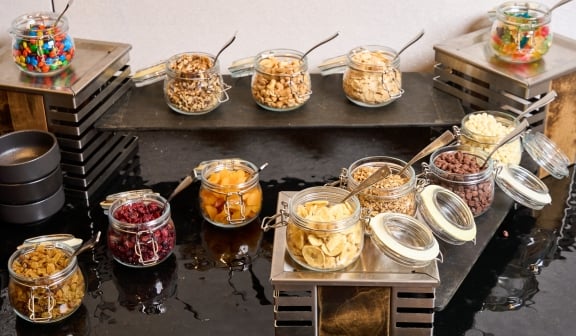 A snack bar with jars of snacks for guests to take at Hotel Clio