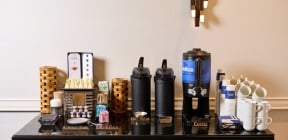 Coffee bar set up with coffee, cups, milks and sweeteners at Hotel Clio