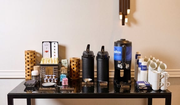 Coffee bar set up with coffee, cups, milks and sweeteners at Hotel Clio