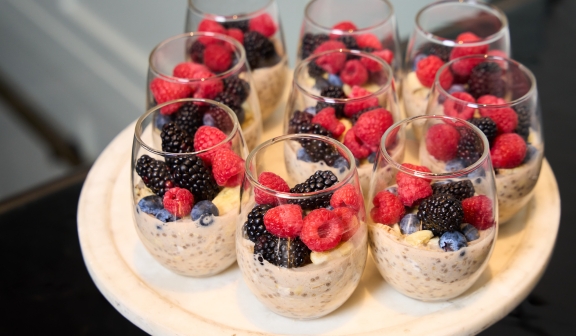 Close up of fresh fruit and oats in glasses prepared by Hotel Clio