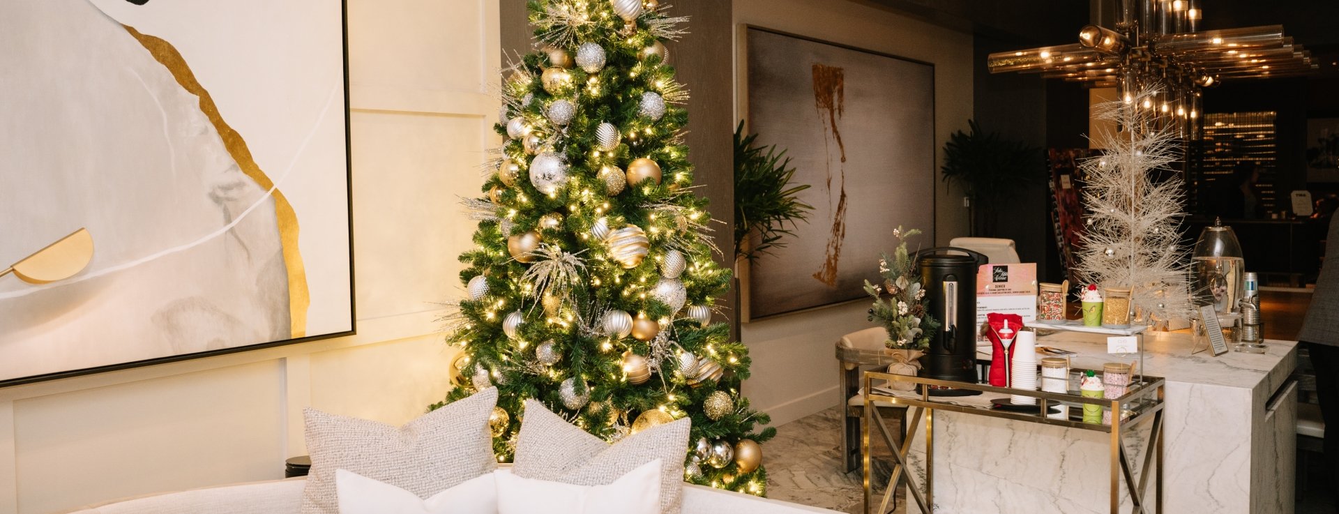 A seating area in front of custom art work at Hotel Clio with christmas decorations in the background